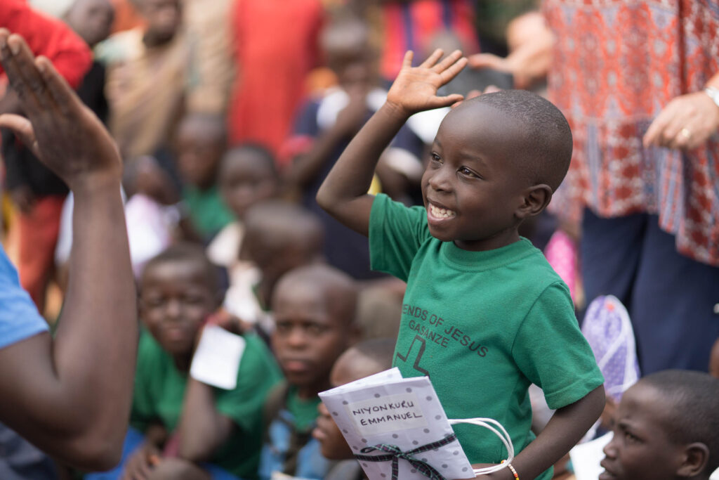 A child going for a high five smiling